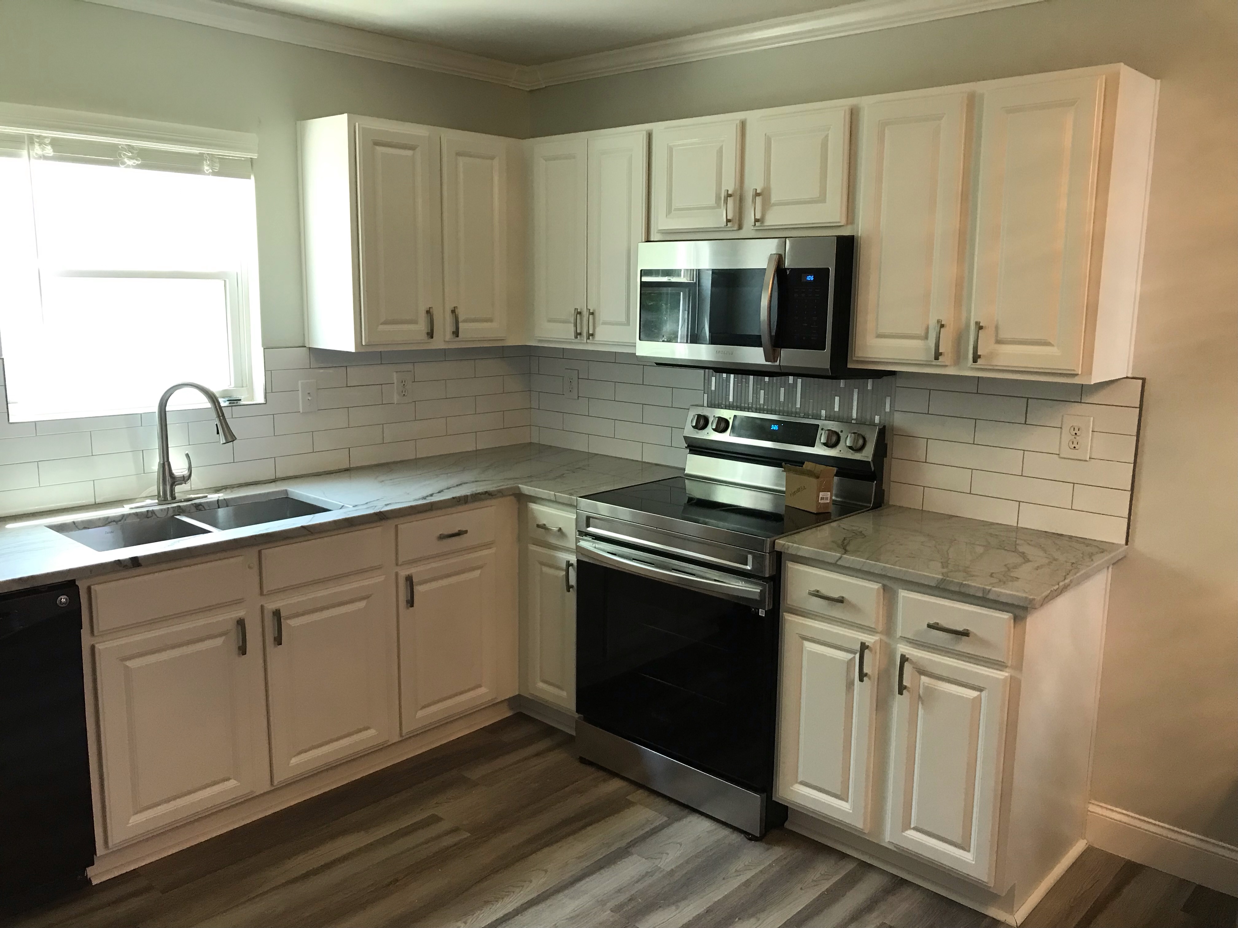 Finished kitchen with bright cabinetry and generous counters