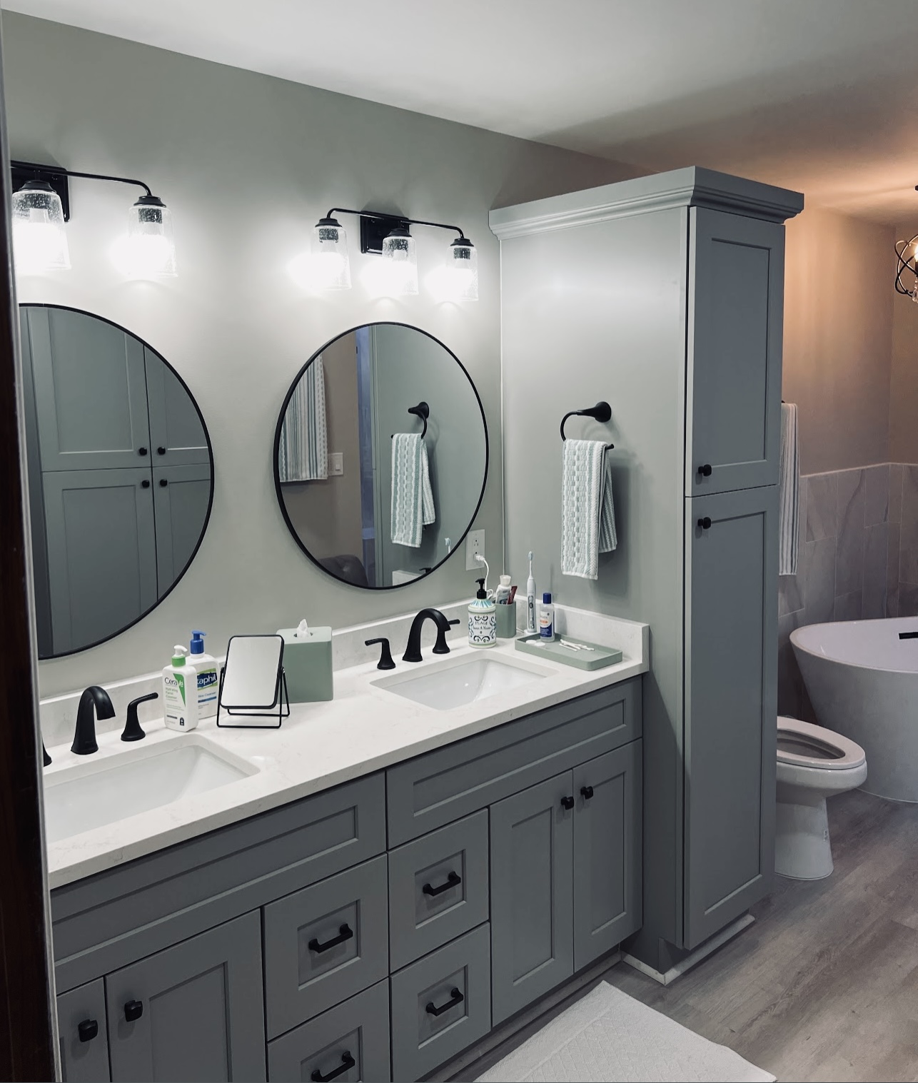 Finished bathroom with a double vanity and custom cabinetry
