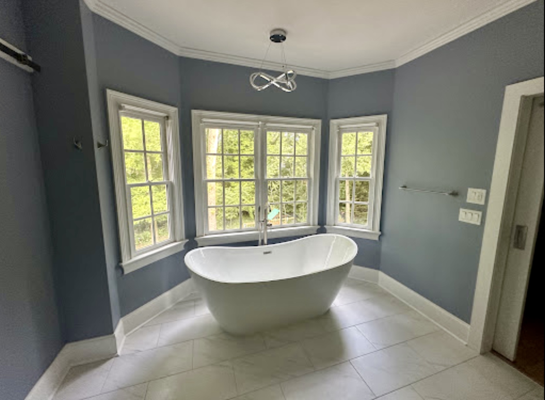 Finished bathroom with a freestanding tub and a spacious, light-filled layout